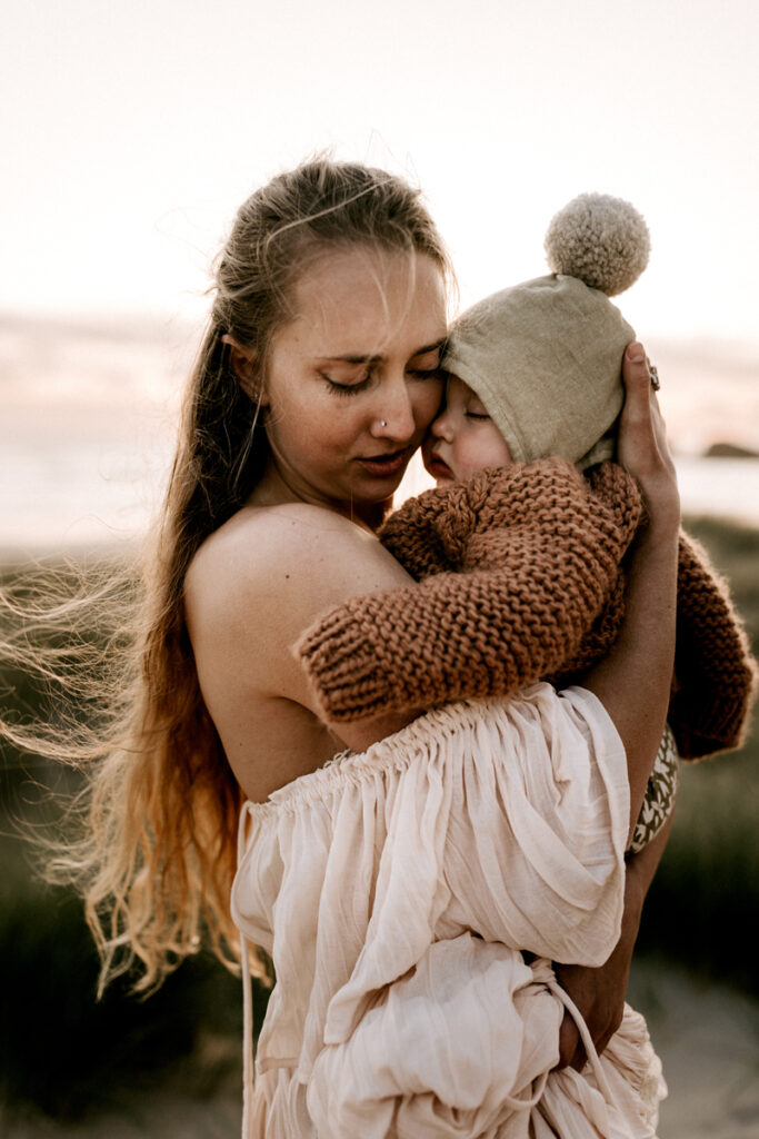Family Photographer. Mother holding child up to her cheek